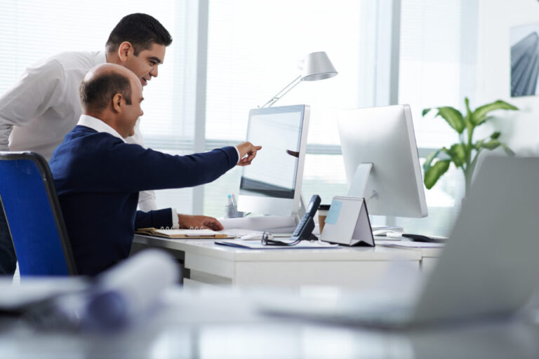 Two men looking at a computer
