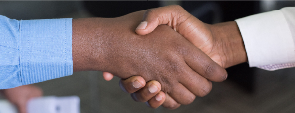 Close up of two African Americans shaking hands.